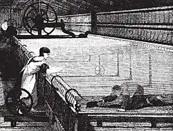Boy with a brush under a cotton spinning machine