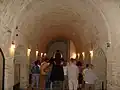 Hallway of sarcophagi full with visitors.