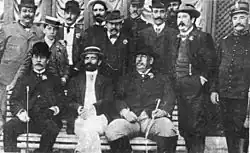 A black and white photo of a group of men in suits.