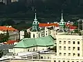 The copper roof and bell towers of the church as seen from the west