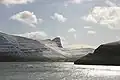 Vágsfjørður, Lopransfjørður and Lopra with the 470 meter high cliff Beinisvørð