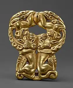 Belt buckle with paired felines attacking ibexes, derived from earlier Scythian art. Ordos, 3rd century BC. Usually described as Xiongnu despite early date.[59][60][61]