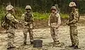 Royal Bermuda Regiment Guns and Assault Pioneers Platoon soldiers and a US Marine discuss training at Camp Lejeune in 2013.