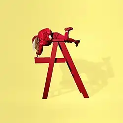 Billie Eilish hanging over a ladder.