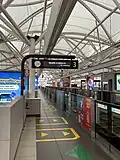 Platform screen doors and information sign at Blok M station
