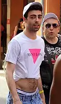 A man wearing an improvised crop top