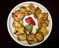 Bread pakora made by frying bread slices coated with gram flour