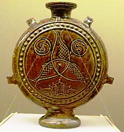 Brown-glazed jar with design of three fish. Yuan Dynasty.