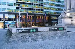Main entrance of 2 Broadway behind an entrance to the Bowling Green station