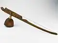 Indonesia, 20th century. Heterchord stick zither, using a gourd resonator. Example of a vertical board being use instead of a bar, called a lath-zither.[3] Still considered bar zither.[1]