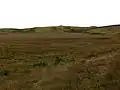 Looking across open moorland to the cairn on Cairn Park, behind Glenchamber