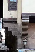 The corbels holding up the upper floor.