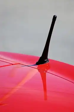 Cell phone UHF whip antenna on car