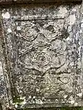 White family arms on a tomb (Party per chevron cotized, three roses - two and one), with text "Memento mori".[9][10]