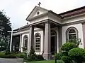 The south side entrance in the form of a diminutive portico.