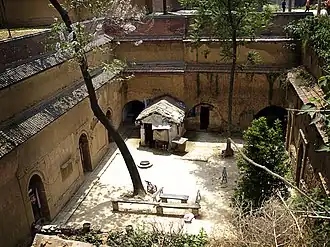 A dugout dwelling enclosing an underground courtyard.