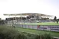Image of the South goalpost and main grandstand from the Southeast corner of the pitch