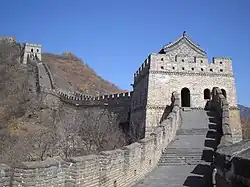 A stone wall going uphill with towers spaced along it (from Human history)