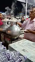 A man making Bhapa Pitha