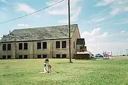 A large church with a decaying roof sits nearly alone in a small town in southwestern Oklahoma.