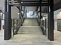 The stairs leading up to Platform 1 to mid level from the western end concourse, October 2024