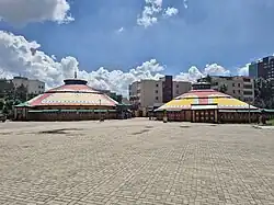 Yurt-shaped building with cars parked outside