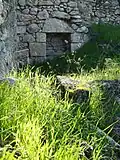What remains of the inside wall of a house, with niche in wall