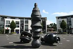 three unidentifiable elements, one like a tall figure or column