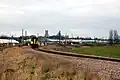A Class 153 operated by Abellio Greater Anglia leaving Ely Dock Junction on a service to Ipswich with the ex-GER mainline in the background and Ely Cathedral on the skyline