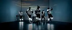 Down with Webster wearing light-up suits while performing "One in a Million" in front of a sunset that is projected on a screen