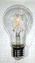 Filaments arranged in a criss-cross pattern to reduce shadows and provide a more uniform illumination