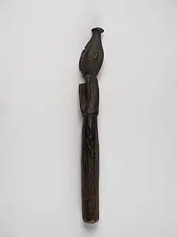 A cylindrical stick with a carved end