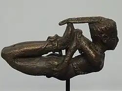 Bronze figurine of a bound man.