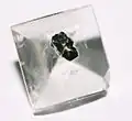 Clear gemstone with metallic inclusion