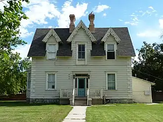 George M. Brown House, built in the 1880s, uses bilateral triparte symmetry in its facade. The decorations are in the Gothic revival style.