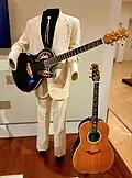 Glen Campbell's 6-string Ovation "Bluebird", based on the Viper solid body, and 6-string acoustic guitars on display at the Musical Instrument Museum in Phoenix, Arizona