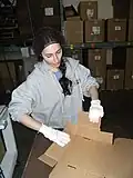 A guest helps out in the candy warehouse at the abbey.