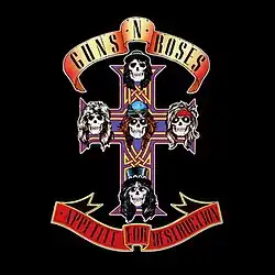 Skulls resembling the band members on an ornate cross on a black background. Above and below the cross are banners that read out the band name and album title.