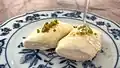 Qatir with a honey-like consistency is drizzled over Halawet el Jibn