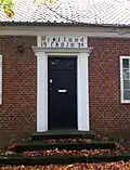 Black door above a set of stairs