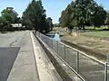 Iron Cove Creek sandwiched between Henley Marine Drive and Wadim (Bill) Jegorow Reserve about 200 metres downstream from Parramatta Road.