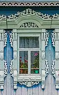 Window with carved platband of the eclectic period. Early 20th century