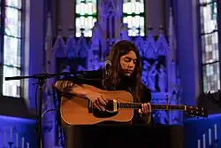 Byrne playing guitar