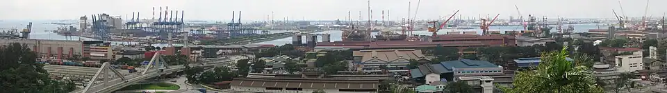 An industrial landscape with buildings and numerous cranes.