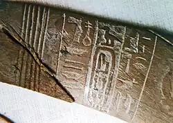 Closeup of the ivory wand showing the king's name.