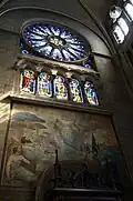 Transept portal with mural and stained glass.