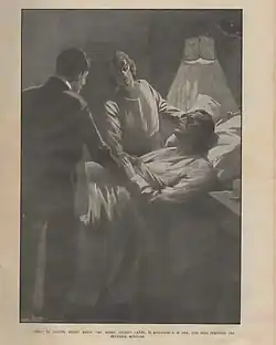 A man and a woman are at the bedside of a bedridden man wearing dark glasses.