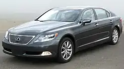 Angled forward view of sedan parked outdoors.
