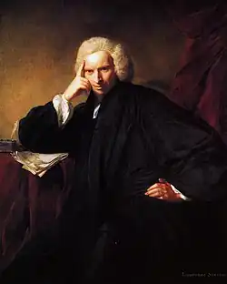 A man in clerical costume and wig, smirking and leaning with a hand on his hip