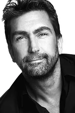 A middle-aged man looking towards the camera.